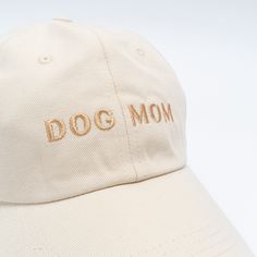 a dog mom hat with embroidered words on it