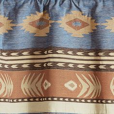 a close up of a blue and brown blanket with an orange design on the bottom