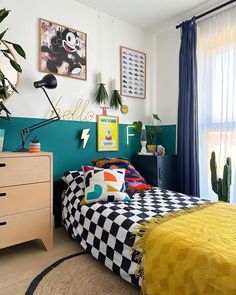 a bedroom decorated in black, white and yellow