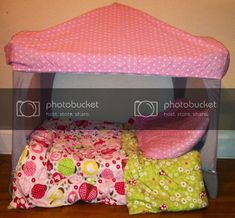 a pink bed with polka dots on it and the caption reads repurpose your pack'n play, simply cut out