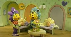 two cartoon characters are standing in front of a table with flowers and cake on it