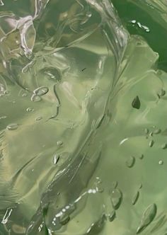 the water is green and has drops of water on it