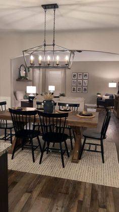 a dining room table and chairs with lights