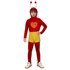 a little boy in a red and yellow costume with horns on his head, standing