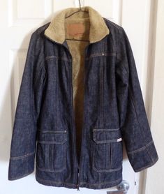 "Super cute Guess blazer jacket lined in beige fleece. Outer is 100% thick dark blue denim. Cozy lining is 70% acrylic 30% polyester. Sleeve linings are 100% nylon. Collar flips up for extra warmth. 2 side pockets, zipper closure. Excellent vintage condition, no signs of wear. No holes, discolorations, odors, or other visible flaws. Stored in a smoke-free home. Nice warm coat that looks flattering & stylish, not bulky.  Length from top of collar to bottom hem: 35\" Pit to pit width: 20\" Total d Denim Outerwear With Zip Fly For Fall, Winter Denim Jacket With Patch Pockets, Retro Winter Denim Jacket With Pockets, Retro Denim Jacket With Pockets For Winter, Winter Retro Denim Jacket, Winter Denim Blue Outerwear With Patch Pockets, Warm Coat, Guess Jeans, Fall Jackets