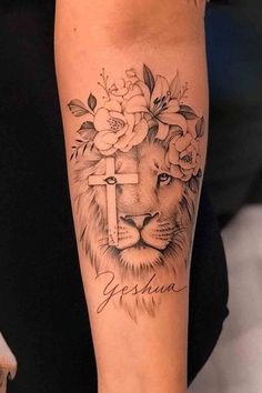 a woman's arm with a lion and flowers on it