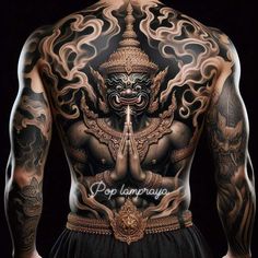 the back of a man's body with tattoos on it and an image of a demon