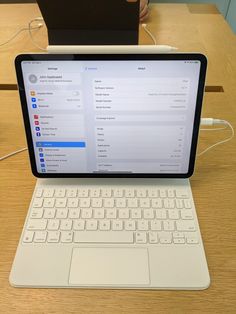 an open laptop computer sitting on top of a wooden table