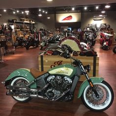 a green motorcycle parked inside of a store