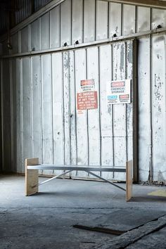 there is a bench in the middle of an empty room with no one around it