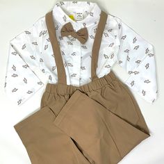 Adorable Baby Boy Outfit, New With Tags, Featuring A Dressy Shirt With Dinosaur Print And Bow Tie And Coordinating Pants With Suspenders. Super Sweet For Special Occasions, Weddings, Church, Events Etc. Tan Khaki Dino I Have Many Many Baby And Kids Items In My Store, Including Another Identical Set Perfect For Boy Twins, Cousins Or Besties. Bundle And Save! White Long Sleeve Sets For First Birthday, White Long Sleeve Set For First Birthday, Spring Dress-up Sets In White, White Dress-up Sets For Spring, White Cotton Dress-up Set, Cute White Dress-up Sets, White Long Sleeve Dress-up Sets, Fitted White Sets For Dress-up, White Fitted Sets For Dress-up