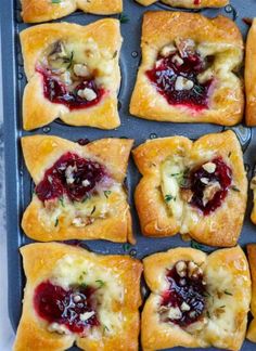 small pastries with cranberry filling on a baking sheet