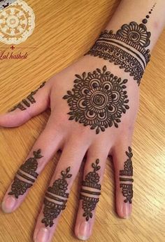 hendi tattoos on the palm of a woman's hand