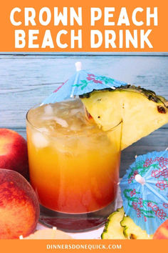 a drink in a glass with an umbrella and some peaches on the table next to it