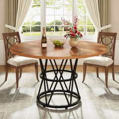 a wooden table with chairs around it in front of a window