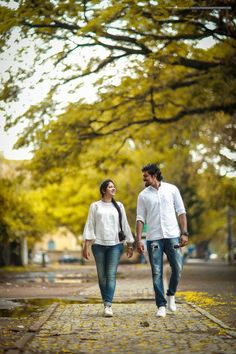 a man and woman are walking down the street