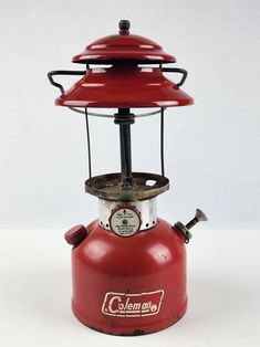 an old fashioned red lantern on a white background