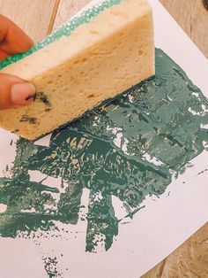 a piece of cake sitting on top of a paper with green sprinkles