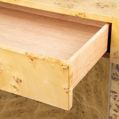 a close up view of a wooden table with drawers on each side and one drawer open