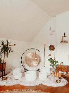 a room filled with lots of white furniture and plants