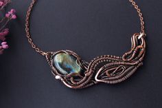 The artisan necklace is made in wire wrapping jewelry technique of copper and labradorite . Copper hammered, patinated, polished and lacquered by special varnish. Labradorite is a very specific stone. Its color can vary and shimmer depending on the lighting, consider this. Color also depends on the settings of your monitor. Proportions: - 9.5 x 4 cm Do not drop and wet Please, contact me in case there are any questions about payment or shipment. My other bracelets https://www.etsy.com/shop/LenaS Handmade Freeform Copper Necklaces, Elegant Electroformed Labradorite Jewelry, Unique Freeform Copper Necklace, Bronze Wire Wrapped Labradorite Necklaces, Bronze Labradorite Wire Wrapped Necklaces, Unique Hand Forged Freeform Necklaces, Elegant Hand Wrapped Copper Necklaces, Artisan Hand Forged Freeform Necklace, Artisan Hand-forged Freeform Necklace