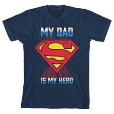 Let heroics abound with this boy's Superman tee. The shirt features Superman's logo and the saying, "My Dad is My Hero," letting boys celebrate all the superheroes in their life. The words are printed in two-toned letters of white and blue. The red S in the yellow diamond creates a red shadow that seems to reflect from the logo. The shirt comes in a navy short sleeve crew neck so boys can beat the heat, stay comfortable, and look stylish. The t-shirt is made with sustainably grown cotton and ren Pre-shrunk Superhero T-shirt For Fan Conventions, Superhero Pre-shrunk T-shirt For Fan Conventions, Superhero Letter Print T-shirt, Superhero Short Sleeve T-shirt With Letter Print, Superhero Cotton T-shirt With Letter Print, Superhero Fan Merchandise Tops With Letter Print, Superhero Letter Print Tops For Fans, Superhero Letter Print Tops For Fan Merchandise, Superhero Letter Print Tops As Fan Merchandise