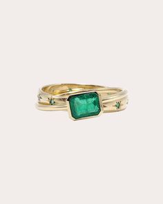 Uniquely tactile, this 14-karat gold ring is formed from two interlocked bands that move around the finger. The wider band's bezel-set emerald mirrors the shimmer of the thinner band's embellished star motifs. 14k yellow gold and emerald Emerald carat: 0.1-0.12 ctw round-cut, 1 ctw emerald-cut Polish with soft cloth Handmade in the USA Measurements Star band width: 2.96mm Gold band width: 1.41mm Gold And Emerald, Rolling Ring, Emerald Band, Green Light, Wide Bands, Emerald Ring, Gold Band, Bezel Setting, Emerald Cut