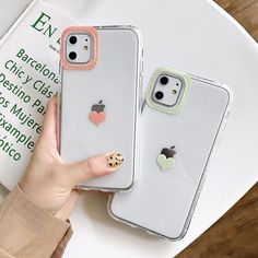 two iphone cases with heart stickers on them