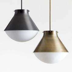 two pendant lights hanging from the ceiling in different shades of grey, white and gold