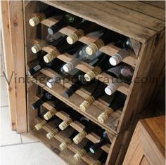 a wooden wine rack filled with lots of bottles on top of a tiled floor next to a cabinet