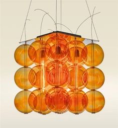 an orange chandelier hanging from the ceiling with many lights on top of it