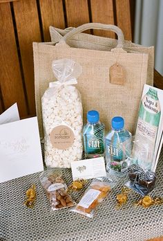 a table topped with a bag filled with lots of candy and candies next to other items