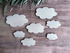 paper clouds are arranged on a wooden surface