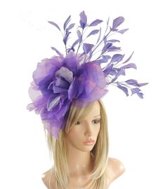 Hats By Cressida Ascot Fascinators, Wedding Hats & Kentucky Derby Hats Purple & Lilac Hayley Feather and Silk Fascinator Hat A mass of purple feathers surround a large purple silk rose flower Flower is about 10 inches wide, feathers about 8-10 inches We can do this in many colours Mounted with a matching headband. If you prefer a headband to match your hair, please make a note at check out what colour headband you want. The Hayley Fascinator Hat is perfect for any special occasion, whether it's a glamorous horse race like the Kentucky Derby or a formal affair like Royal Ascot. This stunning hat features a large silk rose flower, surrounded by a gorgeous mass of feathers, making it a truly elegant headpiece. It's perfect for the mother of the bride or any woman in need of a formal hat. The Purple Summer Fascinator, Summer Purple Fascinator, Fitted Purple Hat For Spring, Purple Mini Hats For Summer Church Events, Purple Mini Hats For Church In Summer, Purple Mini Hats For Summer Church, Summer Purple Mini Hats For Church, Purple Fascinator For Spring Party, Purple Evening Fascinator For Spring