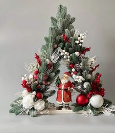 a christmas scene with santa claus and pine cones on the top, surrounded by evergreen branches