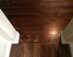 an empty room with wood floors and white trim