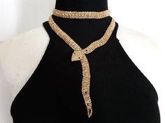 Striking Shiny Gold Tone Metal Coated With Champagne Colored Glass Rhinestones Wrap Around Snake  Long Short Choker Necklace or Wear as a Belt Party Halloween Fashion Jewelry 39" Long Very good to excellent condition clean and ready to wear!  Measuring approx. 39"L from tip head to tail by 7/8" at the widest point.  For more brand names of vintage jewelry and accessories please see our "High End Vintage Jewelry" Shop Section: https://www.etsy.com/shop/lizystuff?section_id=12189340 Please take a Gold Rhinestone Choker For Party, Gold Rhinestone Choker For Evening, Gold Bling Choker For Party, Wrap Around Snake, Party Halloween, Halloween Fashion, Halloween Jewelry, Champagne Color, Long Shorts