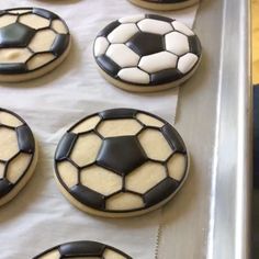 cookies decorated with soccer balls on a baking sheet