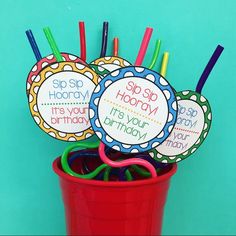 colorful birthday cupcake toppers in a red bucket