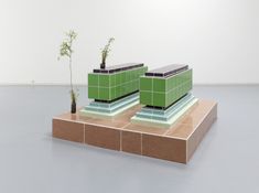 two green planters sitting on top of blocks