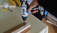 a person is using a drill to cut wood with a cordless drilldriver