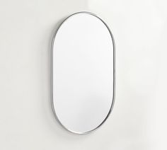 an oval mirror mounted on the wall