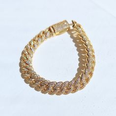 Get ready to sparkle with our Gold Diamond Cuban Link Bracelet dipped in real 18k gold. The perfect gift for a special someone, or simply treat yourself to some bling! An elegant, unique piece that many women would love to add to their collection. ✔Hypoallergenic ✔Water Resistant ✔Quality Guaranteed ✔Handmade Size: 7 inches length, 10mm width Material: 18k gold plated Gold Plated Bangle Chain Bracelet For Parties, Yellow Gold Iced Out Cuban Link Bracelet, Yellow Gold Bracelets With Adjustable Chain And Cubic Zirconia, Elegant Iced Out Tennis Bracelet For Gifts, Elegant Iced Out Bracelets For Gifts, Elegant Iced Out Bracelet For Gift, Gold Plated Adjustable Chain Bracelet For Party, Party Gold Plated Bracelet With Adjustable Chain, Gold Plated Gold Bracelet With Adjustable Chain For Party