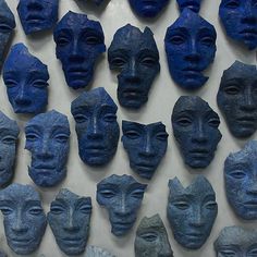 many blue masks are arranged on the wall