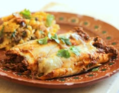 two enchiladas are on a plate with green garnish