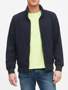 Look closely: this lightweight bomber jacket has a network of tiny perforations, optimally spaced to make it super breathable and perfect in warm weather.  Plus, it's also engineered to be water-repellent and wrinkle resistant.  Stand collar with packable hood.  Zip front.  Front pockets and internal chest pocket.  Lined through the front and sleeves.  Standard fit.  Long sleeves.  Hits at the hip.  Center back length (size M): Regular 26. 5", Tall 28" Sleeve length: Regular 35. 5", Tall 37" Mod Casual Nylon Windbreaker With Zip Fly, Solid Color Nylon Track Jacket For Spring, Navy Casual Nylon Track Jacket, Navy Nylon Spring Outerwear, Navy Nylon Outerwear For Spring, Spring Nylon Track Jacket With Zipper Closure, Flight Jacket, Mens Clothing Styles, Stand Collar