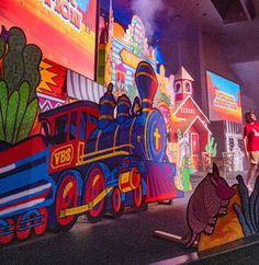 children's museum display with colorful train and cartoon characters