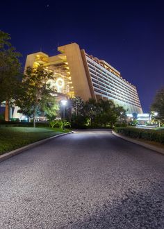 an empty street in front of a hotel at night