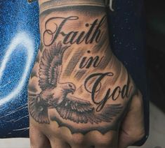 a person with a tattoo on their hand and the words faith in god written on it