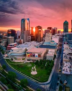 an aerial view of a city at sunset